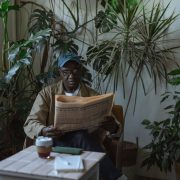 photo of an eldelry man reading newspaper