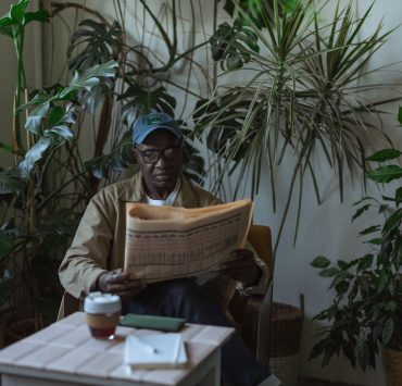 photo of an eldelry man reading newspaper