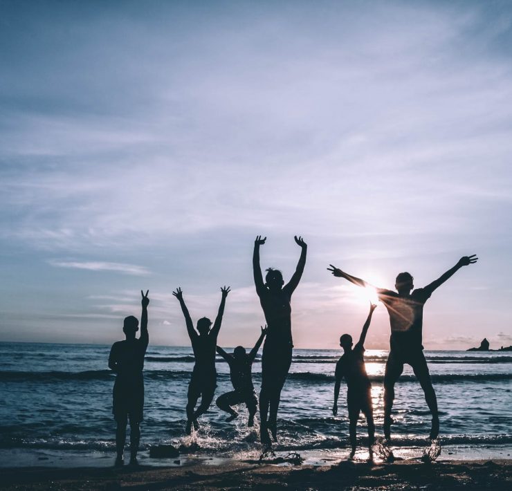 silhouette of people by the seashore