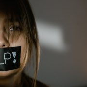 a woman with tape on her mouth