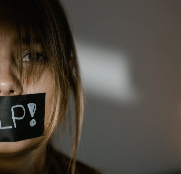 a woman with tape on her mouth