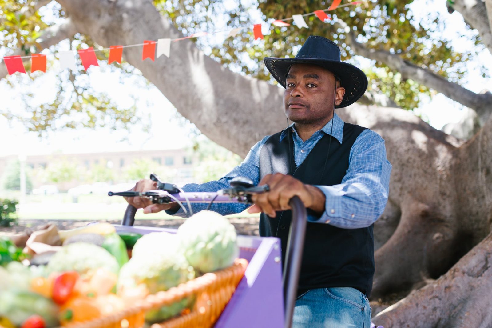 man in blue and white plaid long sleeve shirt and blue denim jeans wearing black hat
