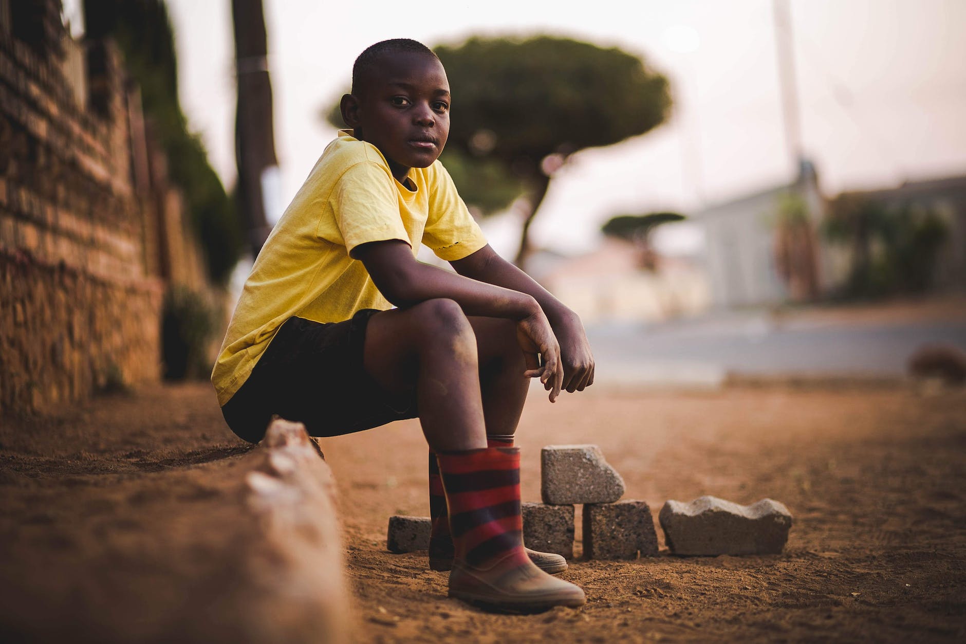 boy wearing yellow crew neck shirt and black short