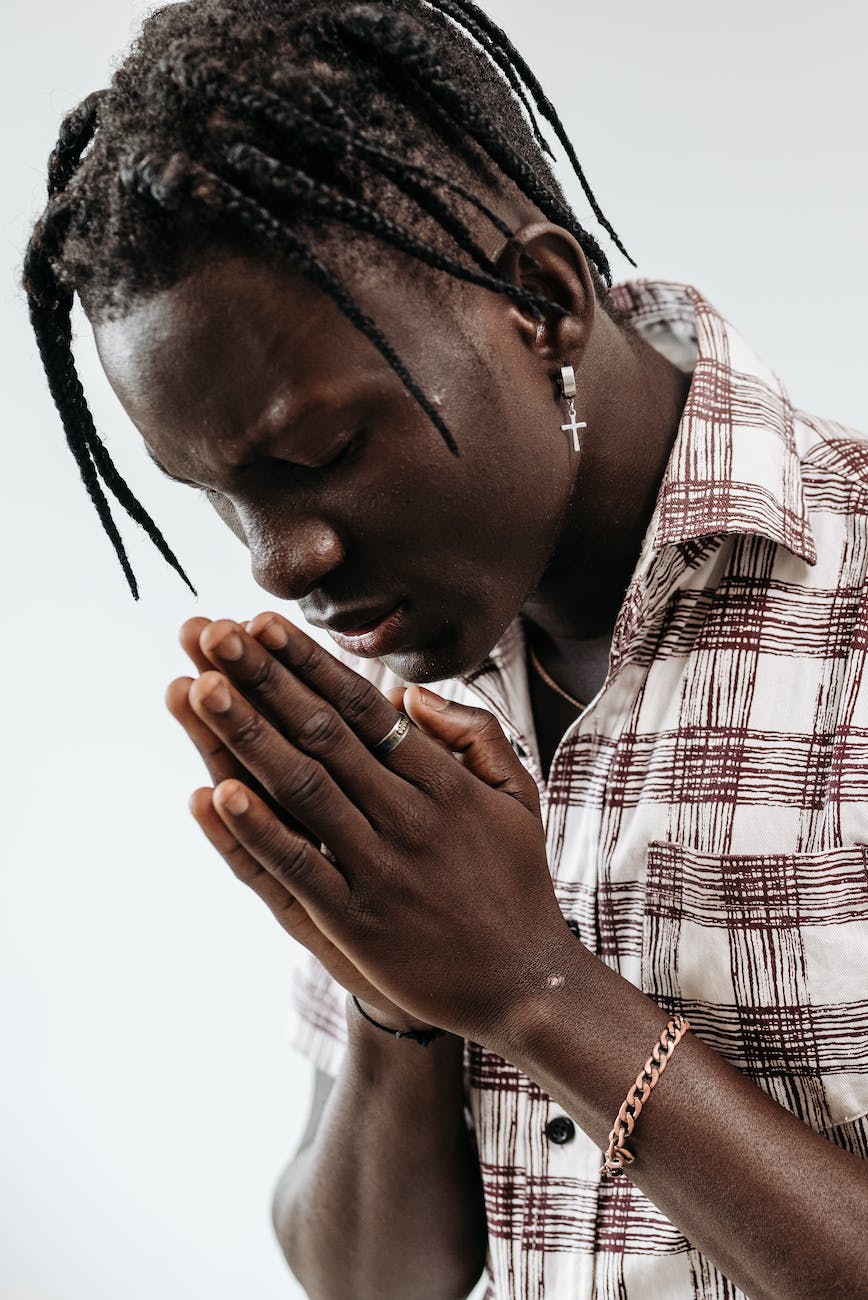man with eyes closed while praying