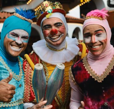 three jugglers with smiling faces