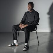 man in black button up shirt sitting on black chair