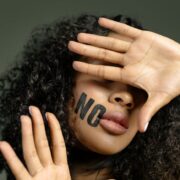 close up photo of woman covering her face