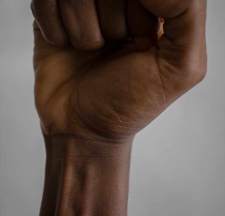 crop black person raising fist