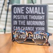 photo of a sign and eyeglasses on table
