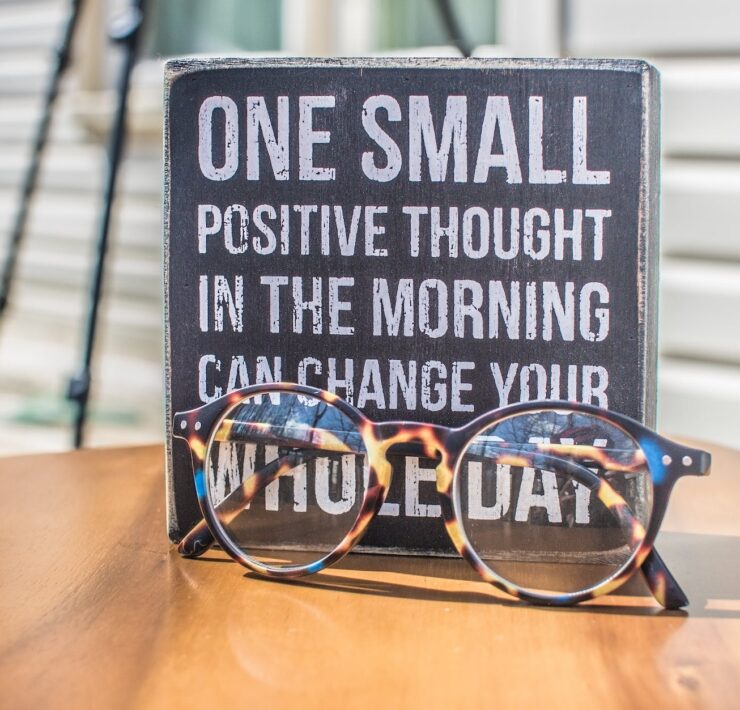 photo of a sign and eyeglasses on table