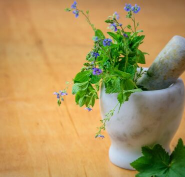 purple petaled flowers in mortar and pestle