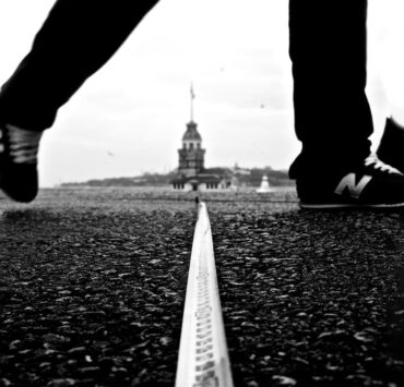 close up of man crossing border on ground
