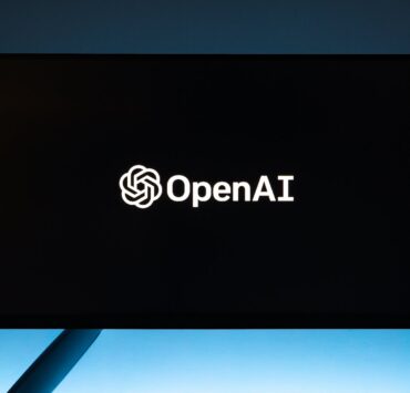 monitor screen with openai logo on black background