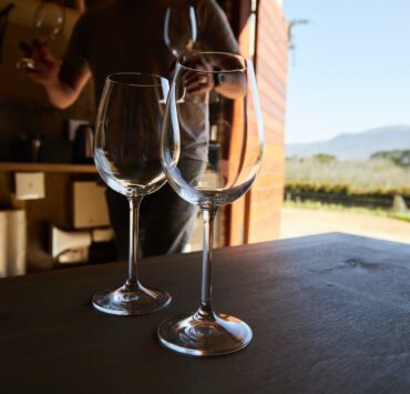 wineglasses on table in barn at vineyard