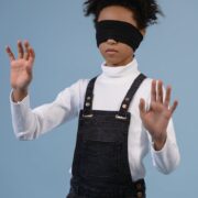a child with blindfold feeling the surroundings