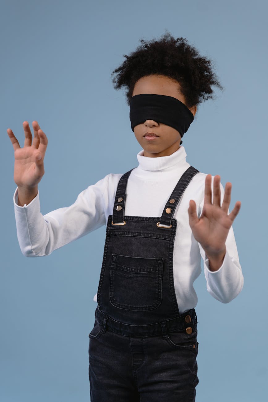 a child with blindfold feeling the surroundings