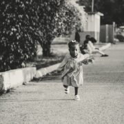 active ethnic kid running on street