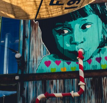 child sipping from pipe graffiti