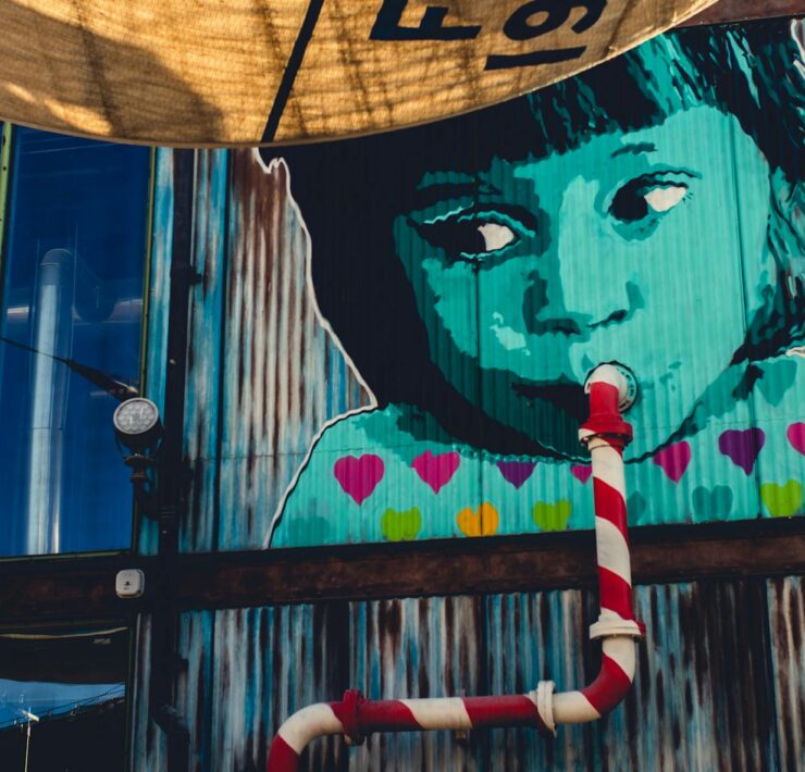 child sipping from pipe graffiti