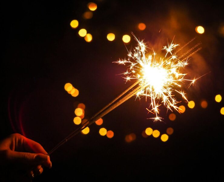 person holding lighted firecracker