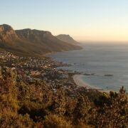 houses near shore surrounded by mountains