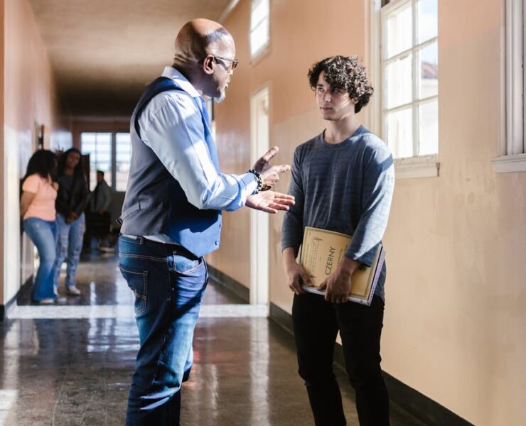 a teacher talking to the boy