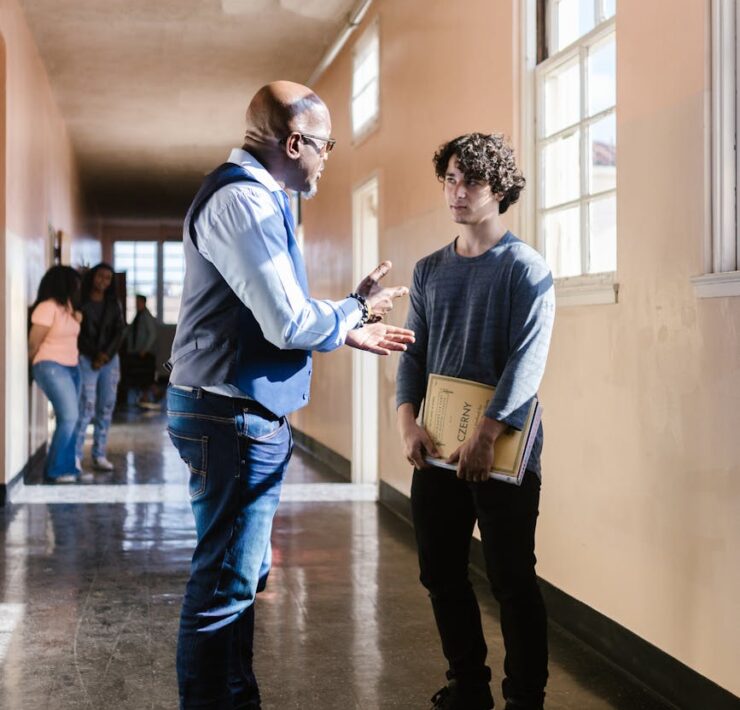 a teacher talking to the boy